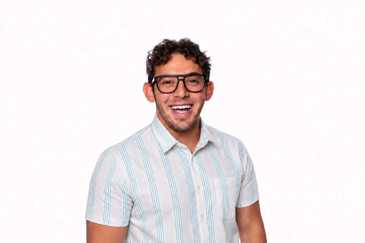 Michael Hanna-Butros Meyering, smiling with short curly hair and glasses